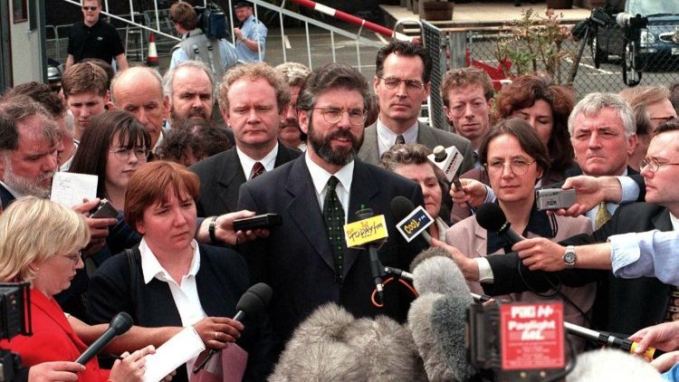 This file photo from July 1, 1998 shows Sinn Fein leader Gerry Adams (R) and Martin McGuinness (L) arriving at the historic first session of the newly-elected Northern Ireland Assembly in Belfast