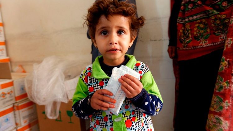 A Yemeni child suffering from malnutrition being fed at a medical centre. 
