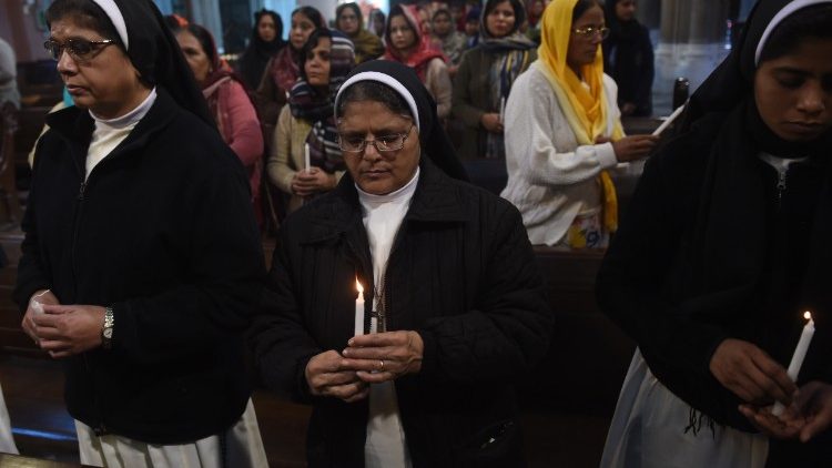 Pakistani Christians take part in a service for the victims of a suicide attack at the Sacred Heart Cathedral in Lahore in 2017