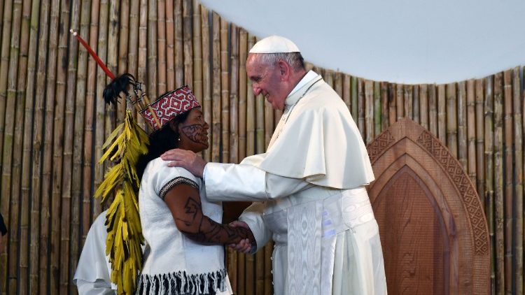 Pope Francis greets an indigenous woman during a meeting with indigenous communities of the Amazon during his visit to Perù 