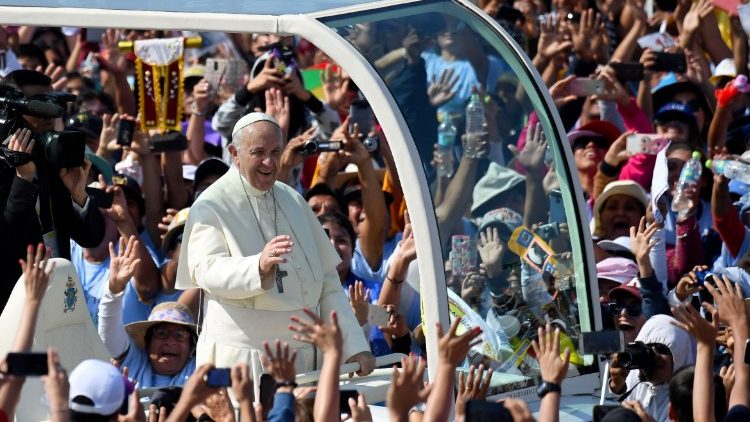 Pope Francis rides through the crowds on his way to celebrate Mass in Trujillo