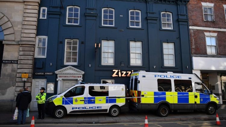 Police stand guard outside a restaurant in England where a former Russian spy was believed to have been poisoned 