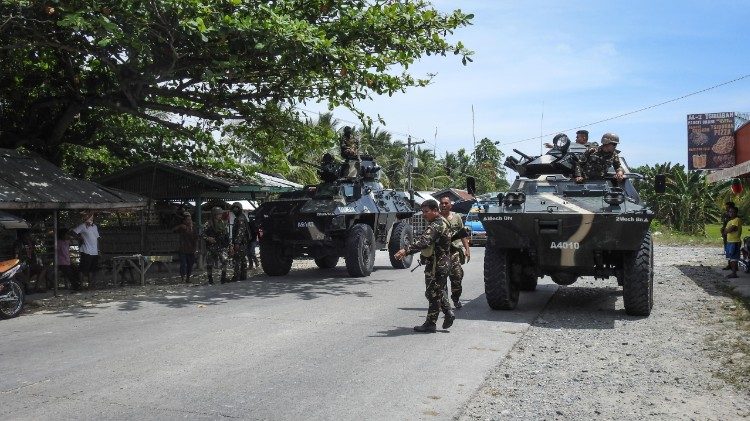 Fillipino soldiers patrol a road in the southern island of Mindanao which is under martial law