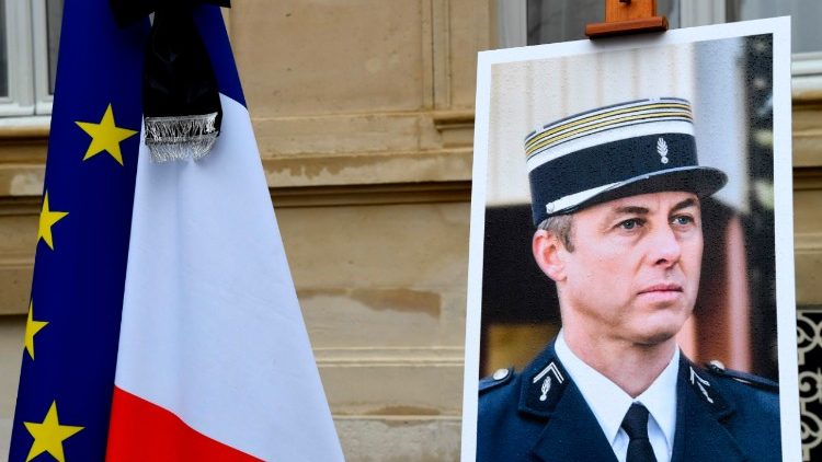 A picture of French gendarme Arnaud Beltrame outside the Interior Ministry during a day of national mourning on Wednesday