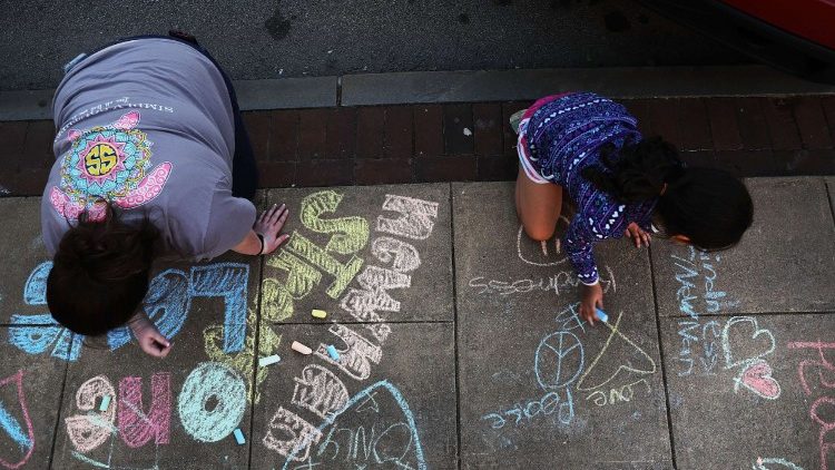 Families write messages of racial and community unity