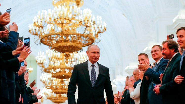 Russian President-elect Vladimir Putin walks to take the oath of office at the Kremlin