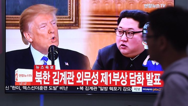 A television news screen in Seoul shows footage of  the North Korean leader and the US President ahead of a planned summit
