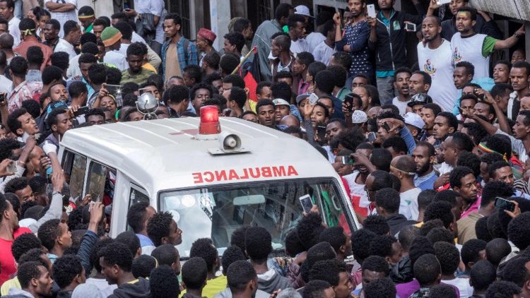 Ethiopians gather round an ambulance after an explosion in Addis Ababa