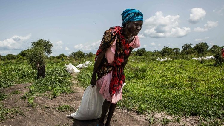 Một phụ nữ Nam Sudan nhận đồ cứu trợ