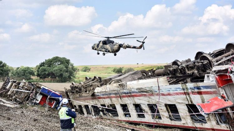 A helicopter flies over the site of a deadly train crash in Turkey