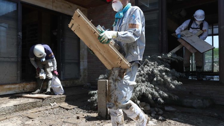 Volunteers cleaning a home in Kurashiki, following the recent floods that hit south-west Japan.  
