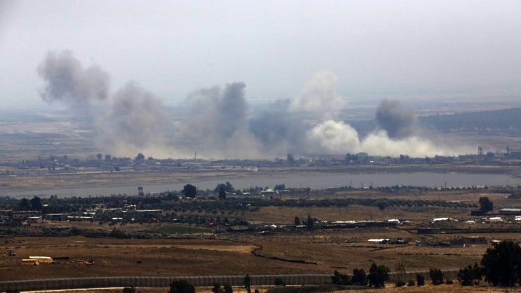 Smoke rises from buildings from air stricks on the border between Syria and Israeli-occupied Golan Heights.