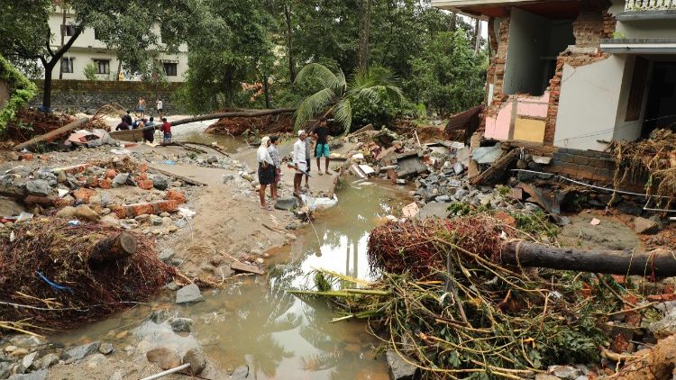 Eine Familie in Kerala schaut auf ihr zerstörtes Haus