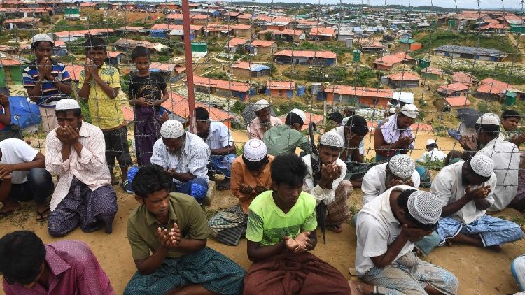 Rohingya refugees pray on the one year anniversary of the military crackcown that caused them to flee to Bangladesh