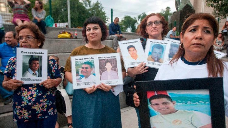 Relatives holding pictures of missing loved ones in Monterrey, Mexico, on the International Day of the Victims of Enforced Disappearance