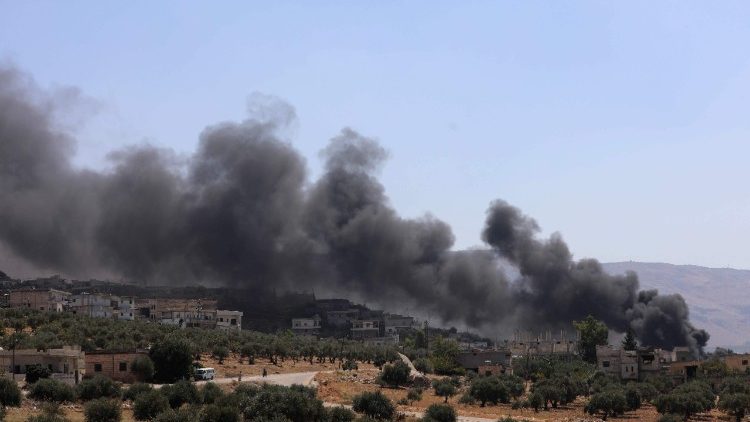 Smoke rises from buildings reportedly hit by Russian air strikes near Idlib on September 4.