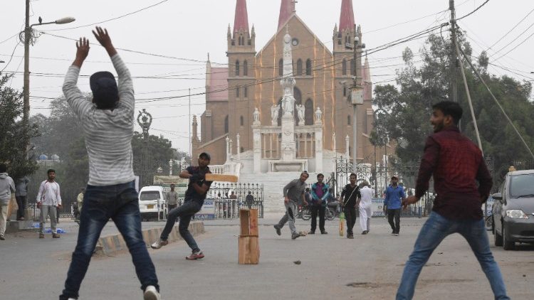 Jugendliche beim Cricket - Im Hintergrund die Kathedrale von Karachi