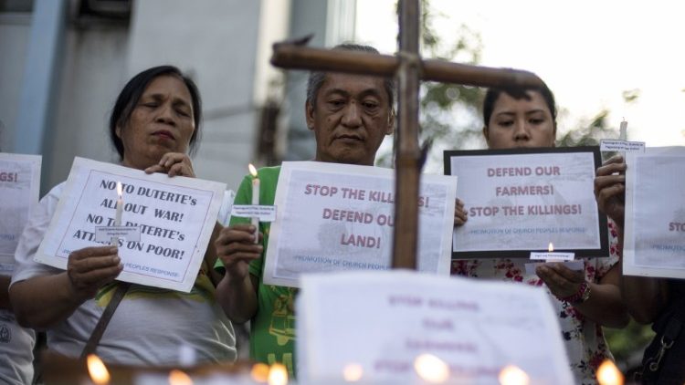 Filipinos protesting the killing of 14 farmers in a crossfire between security forces and suspected communist rebels.
