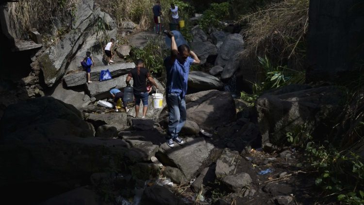 Venezuelans collect water near Caracas during a recent blackout