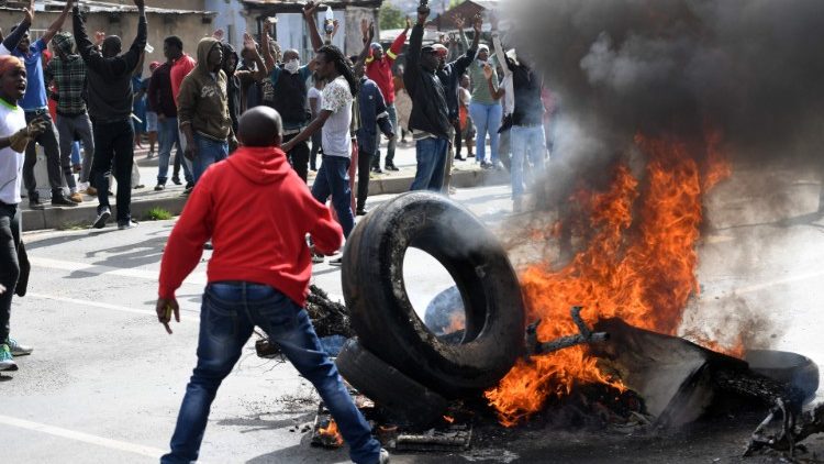 South Africans protest poor service delivery. Protests led to xenophobic violence. 