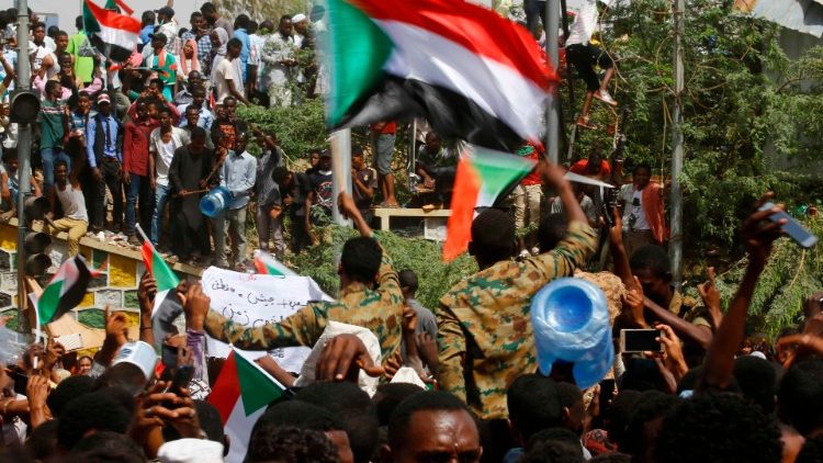 Sudanese demonstrators gather in central Khartoum immediately after the ousting of President Omar al-Bashir