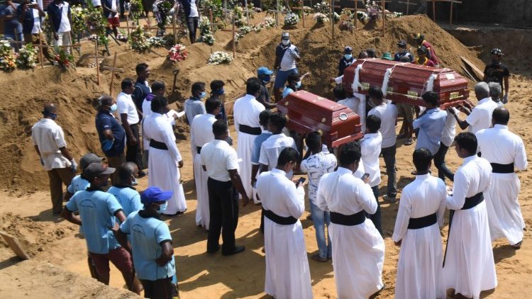 Mourners burying their loved ones in a cemetery  in Negombo, Sri Lanka. 