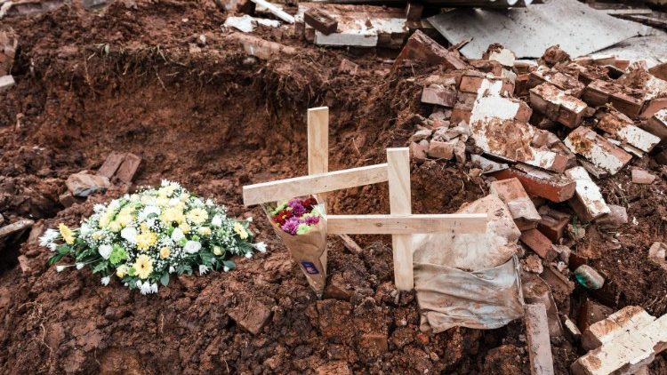 Flowers and crosses placed on the debris after the house of a school carer was destroyed by a mudslide killing 8 people south of Durban in South Africa
