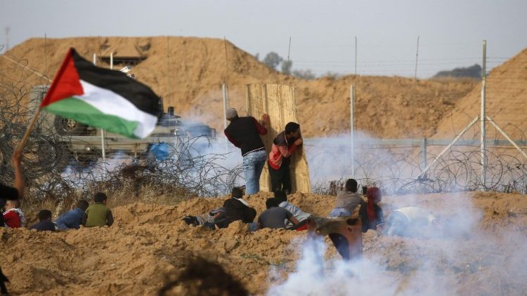 Palestinian protesters clashing with Israeli forces near the border in southern Gaza strip.