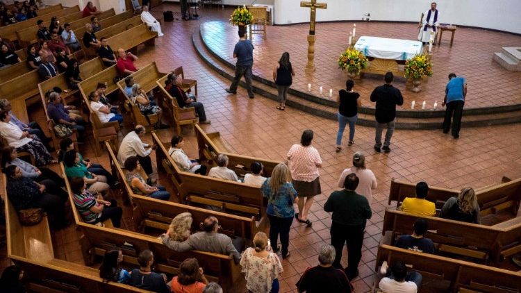 Mourners take part in a Vigil at the St Pius X Catholic Church in El Paso