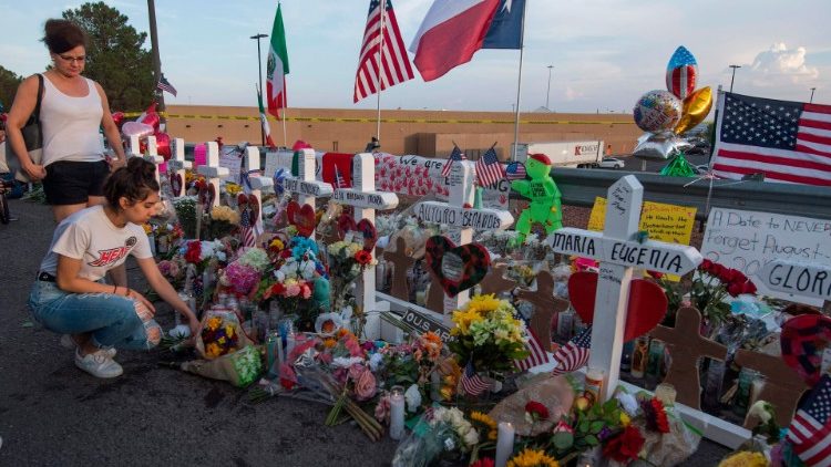 People pay their respects at a makeshift memorial for victims of a shooting in El Paso, Texas