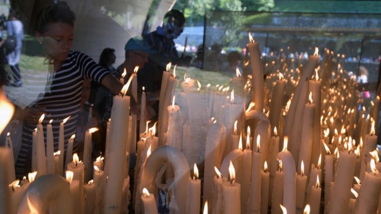 Peregrinos acendem velas no Santuário de Lourdes, na França (imagem de 14 de agosto de 2019)