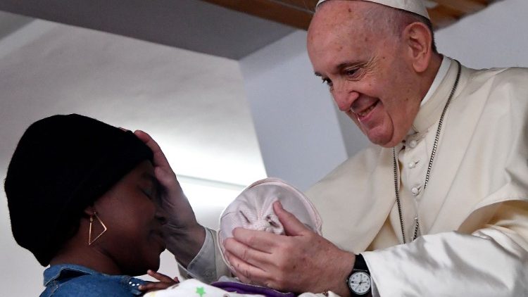 Pope Francis blesses a mother with a baby during his visit at the Zimpeto hospital in Maputo 