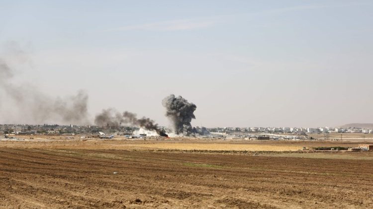 Smoke billows from the Syrian border town of Ras al-Ain