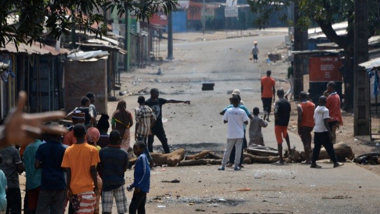 Young people in Conakry block the road as they protest against President Alpha Conde
