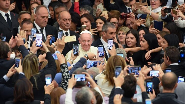 Students and teachers of Rome's LUMSA university take photos of Pope Francis