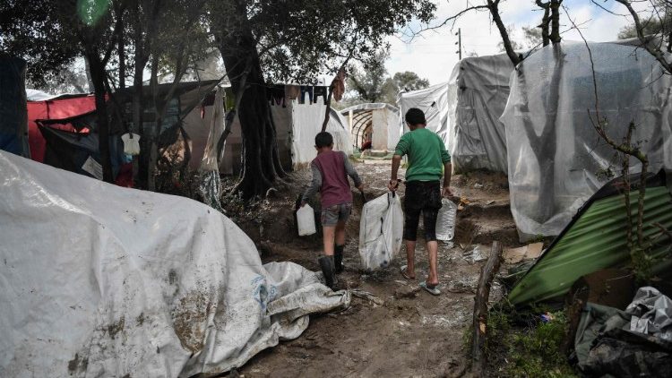 Boys fetching water in a makeshift migrants' camp in the Greek island of Chios. 