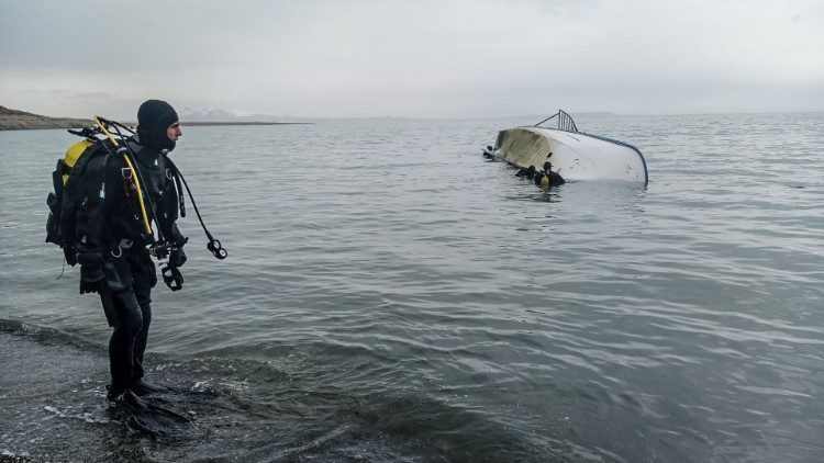 A rescue diver stands on the shores of Lake Van