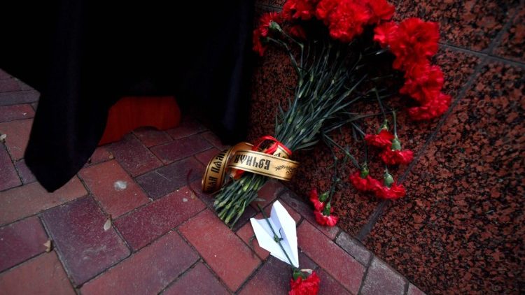 a tribute to the victims of a plane crash are placed outside the Iranian embassy in Kiev