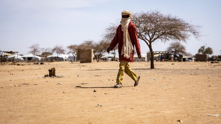 A man walks at a camp sheltering IDPs in Burkina Faso