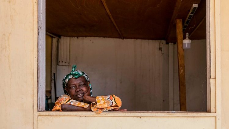 An internally displaced woman poses at a window in Cameroon