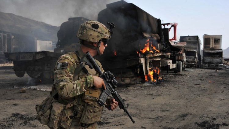 A US soldier investigates the scene of a suicide attack on the Afghan border with Pakistan