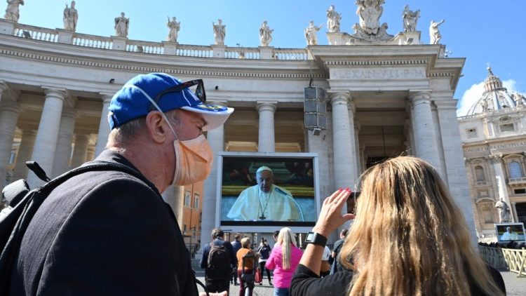 A man is seen wearing a mask during Pope Francis' live streaming of his Sunday Angelus