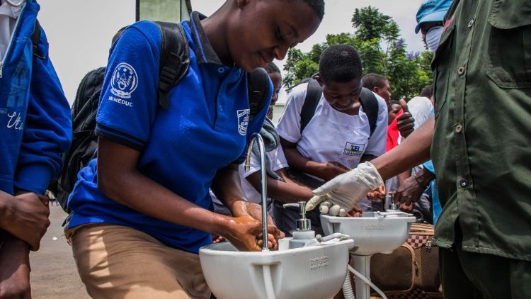 Students inn Rwanda wash their hands at a temporary hand washing point