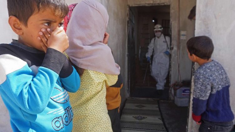 A former school in Syria, inhabited by displaced families, being disinfected. 
