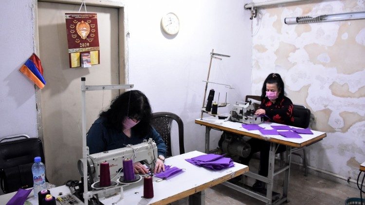 Volunteers sew masks for the poor for protection against Covid-19 in the Syrian city of Aleppo