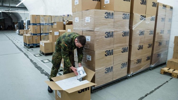 A German Lieutenant unpacks boxes of FFP2 quality masks