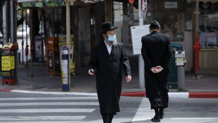 A resident of the Israeli city of Brei Brak near Tel Aviv wears a protective mask