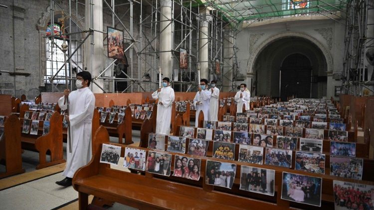 Photos of parishioners taped on church pews of  the Holy Rosary Parish Church of Angeles City, near Manila, the Philippines. 