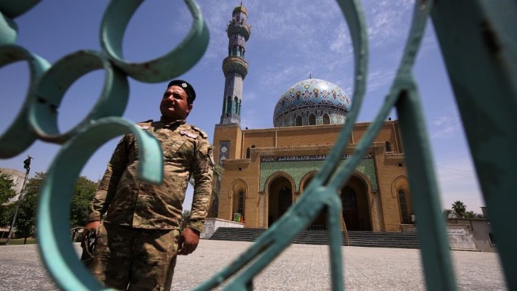 A soldier guards a closed mosque in the Iraqi capital of Baghdad