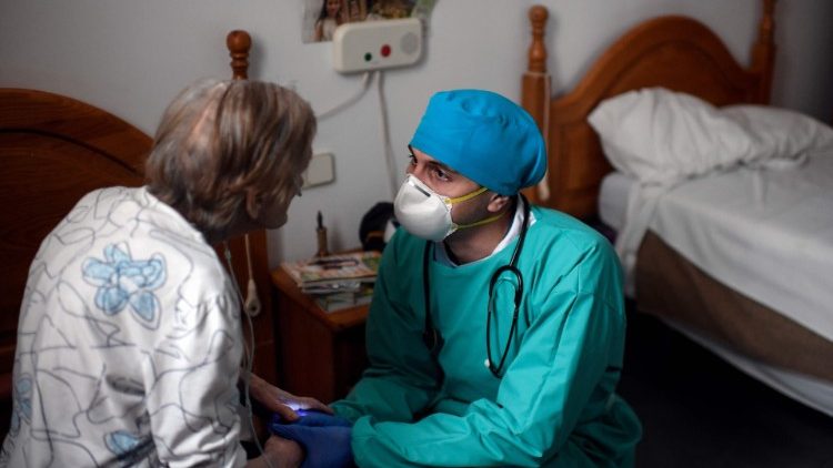 A doctor talking to an elderly Covid-19 patient in Madrid, Spain.  